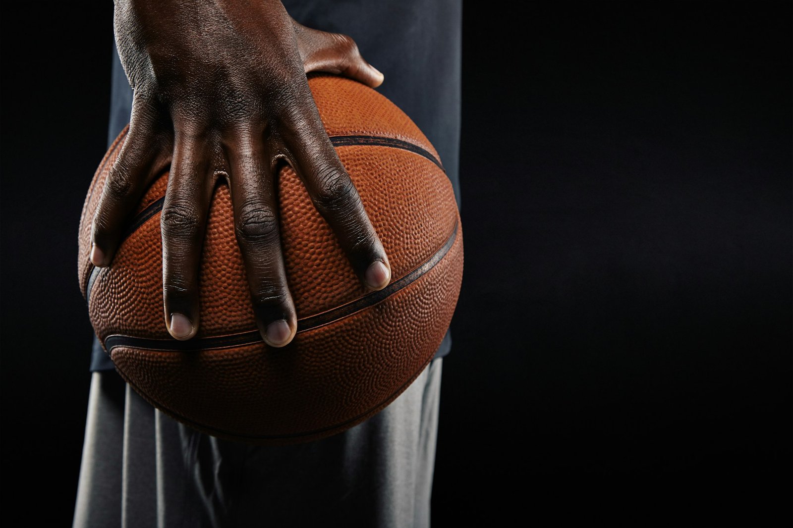 Hand of basketball player holding a ball